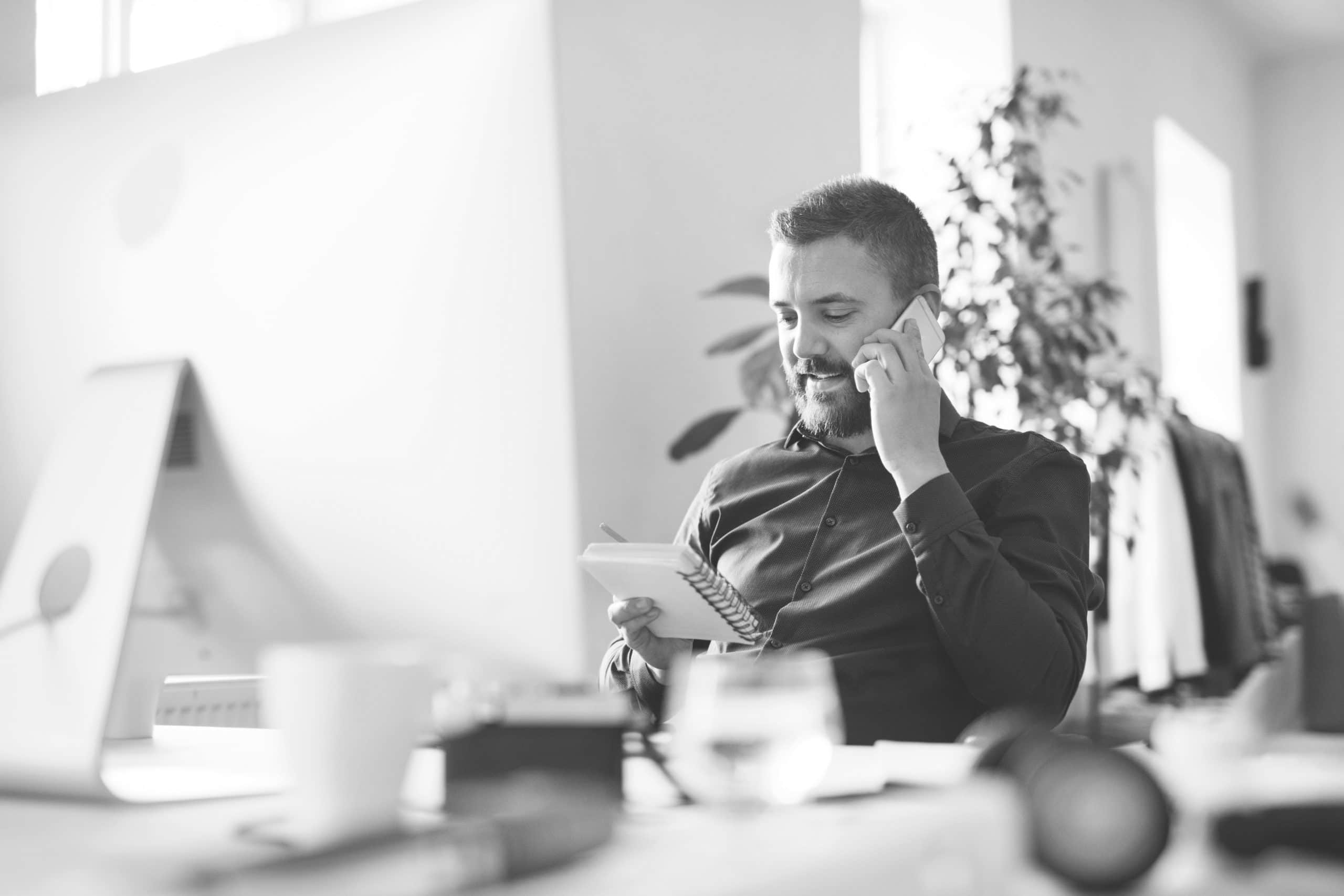 Businessman in wheelchair at the desk in his office.